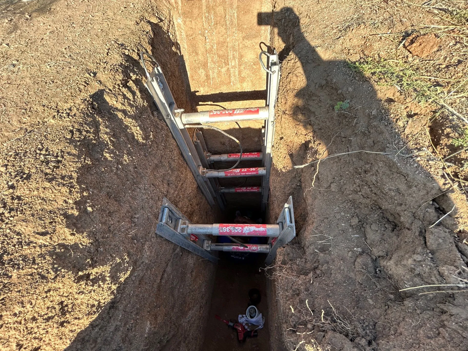 Shored utility trench on a commercial job site dug for a KCM Mechanical line install